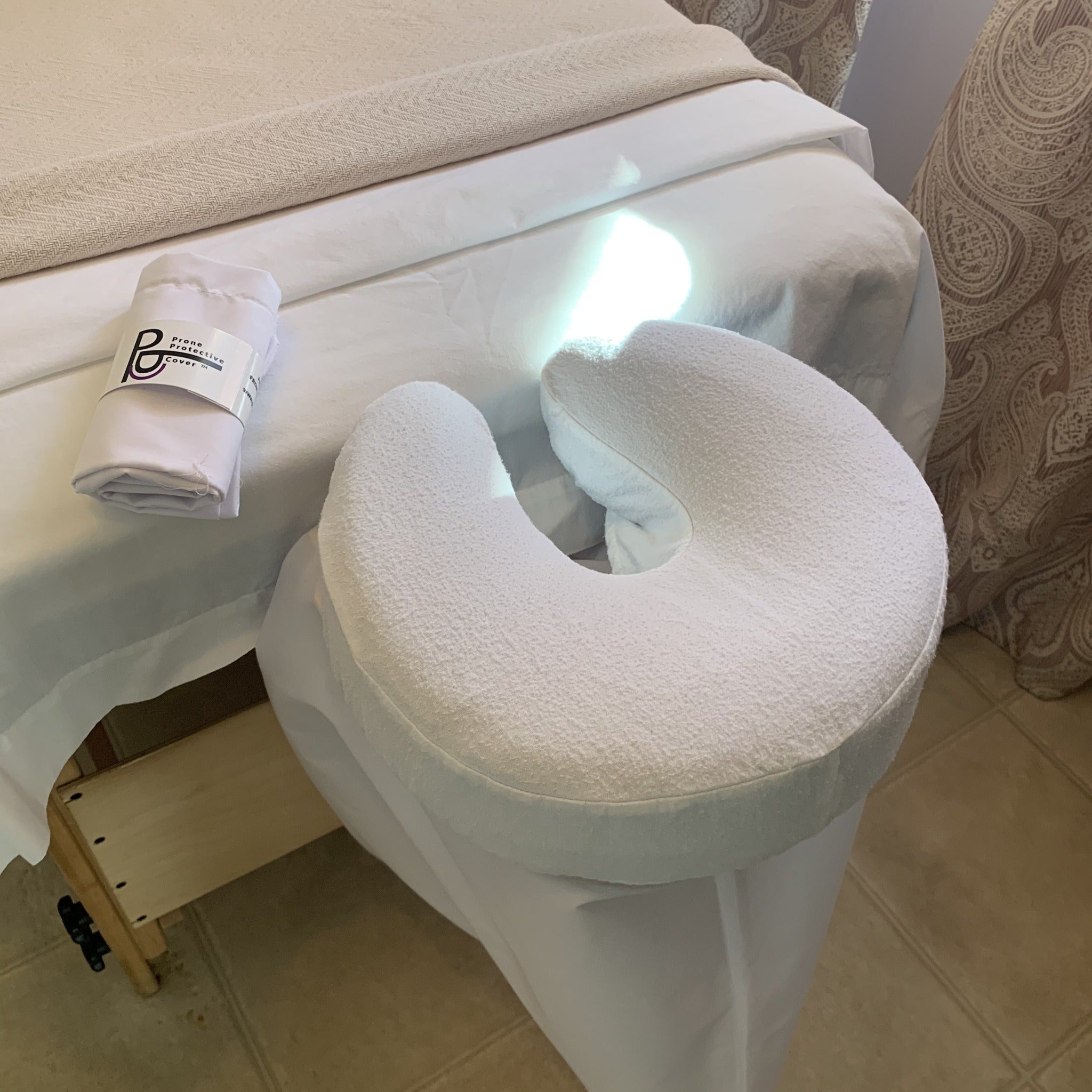 Prone Protective Cover for Clinic, Massage & Spa Tables tucks easily between Face Cushion and Platform.  Reduces feelings of claustrophobia for the client and reduces  &  spread of airborne droplets associated with COVID19.